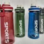 Une image montrant quatre gourdes de sport en plastique translucide alignées. Elles sont de couleurs différentes : une rouge au premier plan à gauche, suivie d'une verte, d'une bleue, et d'une grise à l'arrière-plan à droite