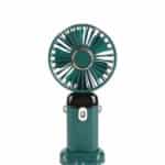 Mini ventilateur de poche vert bouteille avec des touches de doré sur la grille et les attaches latérales, présenté sur un fond blanc uni.